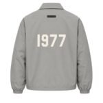 Fear of God Essentials 1977 Nylon Coaches Jacket Grey Back View – Flocked 1977 Logo